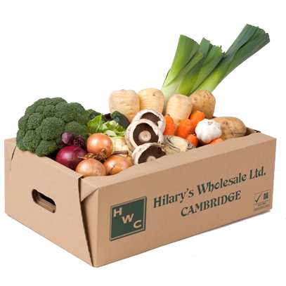 Cardboard box overflows with fresh produce, including broccoli, leeks, parsnips, and mushrooms, from Hilary's Wholesale Ltd.